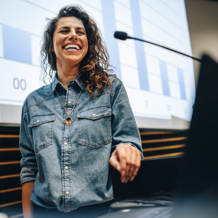 Woman,Speaking,At,A,Business,Summit,And,Smiling.,Successful,Female